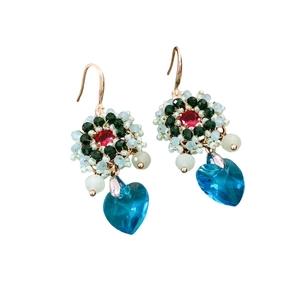 Vintage handmade floral beaded earrings with heart crystal pendant on white background