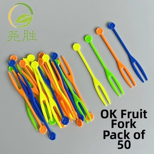 Flat lay of colorful 50-piece plastic fruit forks set with OK design on flat background
