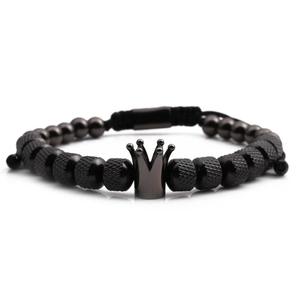 Detailed shot of men's black crown beaded bracelet with matte and polished textures