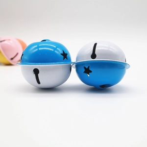 Macro view of blue and white bicolor metal bells with star cutout for crafts
