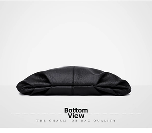 Detail view of the bag's bottom showing premium black lychee leather texture and stitching