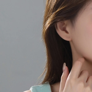 Elegant s925 sterling silver butterfly stud earrings worn by a model for a stylish look