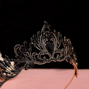 Detailed view of Baroque black gemstone crown with golden metal scrollwork textures