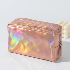 Detail of holographic rose gold laser PU makeup bag with sleek zipper closure