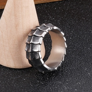 Vintage silver stainless steel dragon scale ring for men displayed on wood stand
