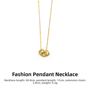 Detail view of gold beaded chain and triple ring pendant with green emerald zircons
