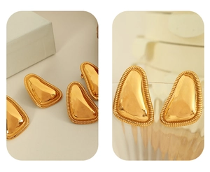 Detail shot of 18K gold plated geometric stud earrings with textured edge and glossy finish