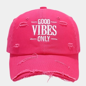 Close-up of distressed rose pink baseball cap with white Good Vibes Only embroidery