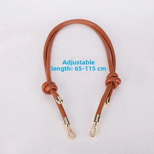Close-up of adjustable brown leather bag strap with gold metal hooks, length 65-115cm