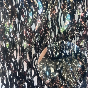 Detail of black holographic star foil fringe curtain with rainbow reflective effect