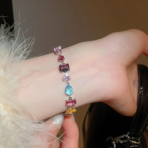Macro view of luxury irregular geometric colorful zircon bracelet on model wrist