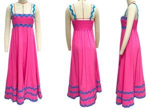 Detail of rose pink dress showing wavy blue trim and smocked back elastic design