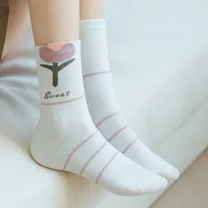 Detail of hand-sewn seamless toe on white cotton mid-calf socks with tulip pattern