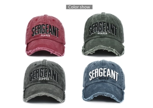 Detail view of washed cotton baseball caps with 3D embroidery and distressed brims