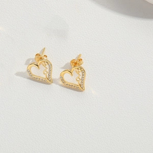Detail of gold heart earrings featuring sparkling pavé crystals and LOVE inscription