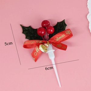 Detailed Christmas cake topper with red berries, green leaves, and gold bells