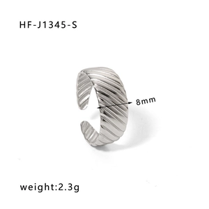 Macro shot of 8mm wide textured stainless steel ring showing ribbed finish and dimensions