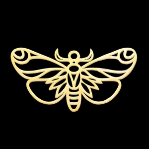 Macro shot of a hollow gold moth pendant made of stainless steel on black background