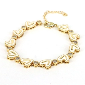 Bohemian gold heart link bracelet with white enamel inlay and sparkling zircon crystals