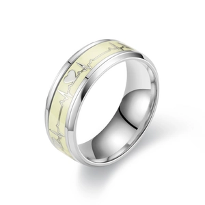 Detailed close-up of luminous heart beat pattern on wide stainless steel band ring