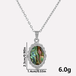 Macro shot showing dimensions of oval abalone shell pendant with silver metal frame