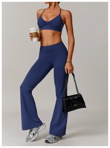 Detail of navy blue V-neck sports bra with ruched front and criss-cross back straps
