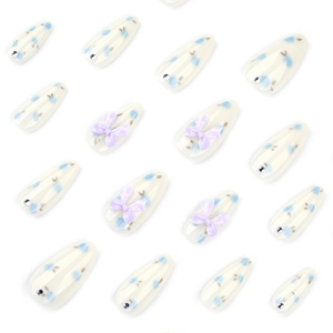 Blueberry style press-on nails with purple bows and floral patterns in almond shape