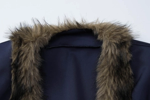 Close-up of faux fur trim collar on a dark blue slim fit jacket for women