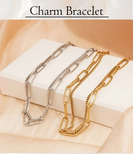 Close-up of gold and silver paperclip chain bracelets displayed on white steps