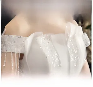 Detailed view of the off-the-shoulder neckline with lace floral patterns and sequins