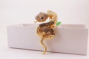Detailed view of a gold snake keychain with sparkling clear and black rhinestones