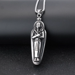 Macro detail of silver Egyptian pharaoh pendant with intricate relief and woven chain