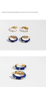 Detail view of white and royal blue enamel C-shape hoop earrings with cubic zirconia stones