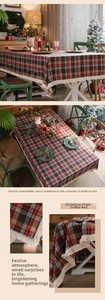 Detailed view of British style red plaid tablecloth featuring white fringe tassels
