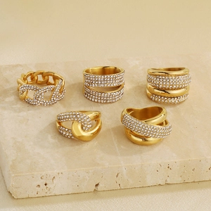 Detailed view of 5-piece gold-plated titanium rings with sparkling zircon pavé setting