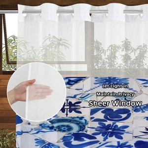 Detail of white waffle sheer curtain with blue floral base showing privacy and light