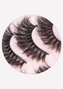 Macro shot of 10 pairs of dense, curly black false eyelashes in a pink tray