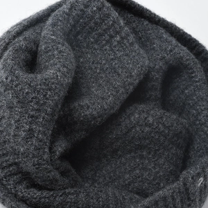 Deep gray wool knit beanie showing dense fiber texture and soft warm material detail