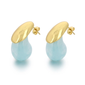 Golden teardrop earrings featuring light blue resin pendants on a clean white background