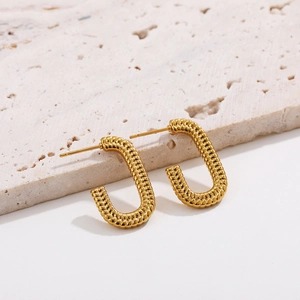 Detail view of 18K gold plated U-shaped earrings with textured rope pattern on stone