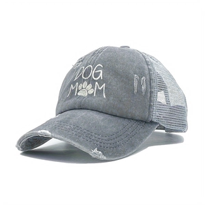 Close-up of distressed gray ponytail baseball cap with DOG MOM embroidery and mesh back