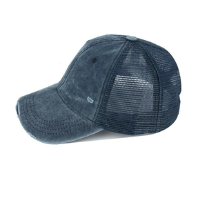Distressed washed navy blue trucker hat with breathable mesh back and torn visor detail