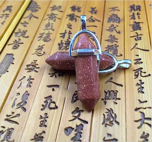 Detail of hexagonal natural stone pendants with silver metal clasps on a bamboo background