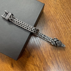 Close-up of vintage Viking wolf head bracelet with heavy stainless steel braided chain