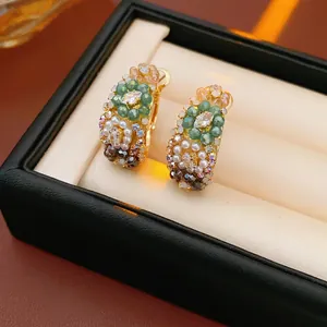 Vintage style gold earrings with green beads and pearls in a jewelry gift box