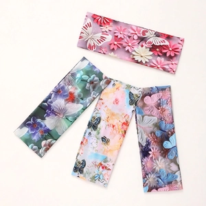 Set of four 3D floral and butterfly print elastic headbands in bohemian style on white background