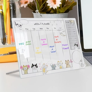 Close-up of acrylic weekly planner with cute cat illustration and metallic stand