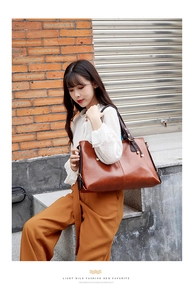 Genuine leather tote bag for women, large capacity shoulder commuting handbag with stylish design.