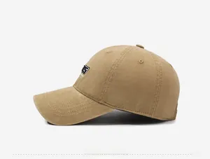 Side view of vintage washed khaki cotton baseball cap with detailed letter embroidery