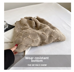 Detailed view of beige chunky knit tote bag showing thick textured diamond weave pattern